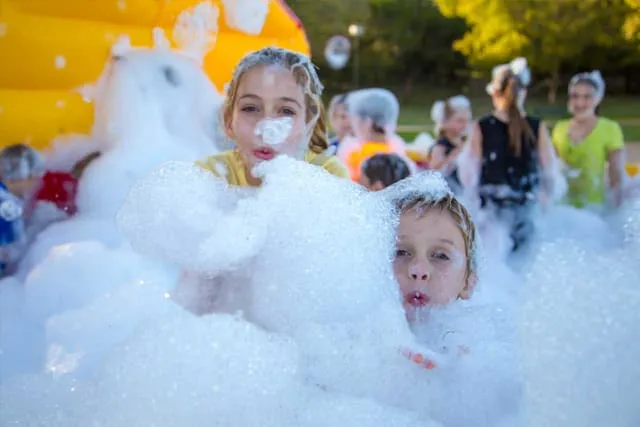 Kids covered in foam from the foam machine