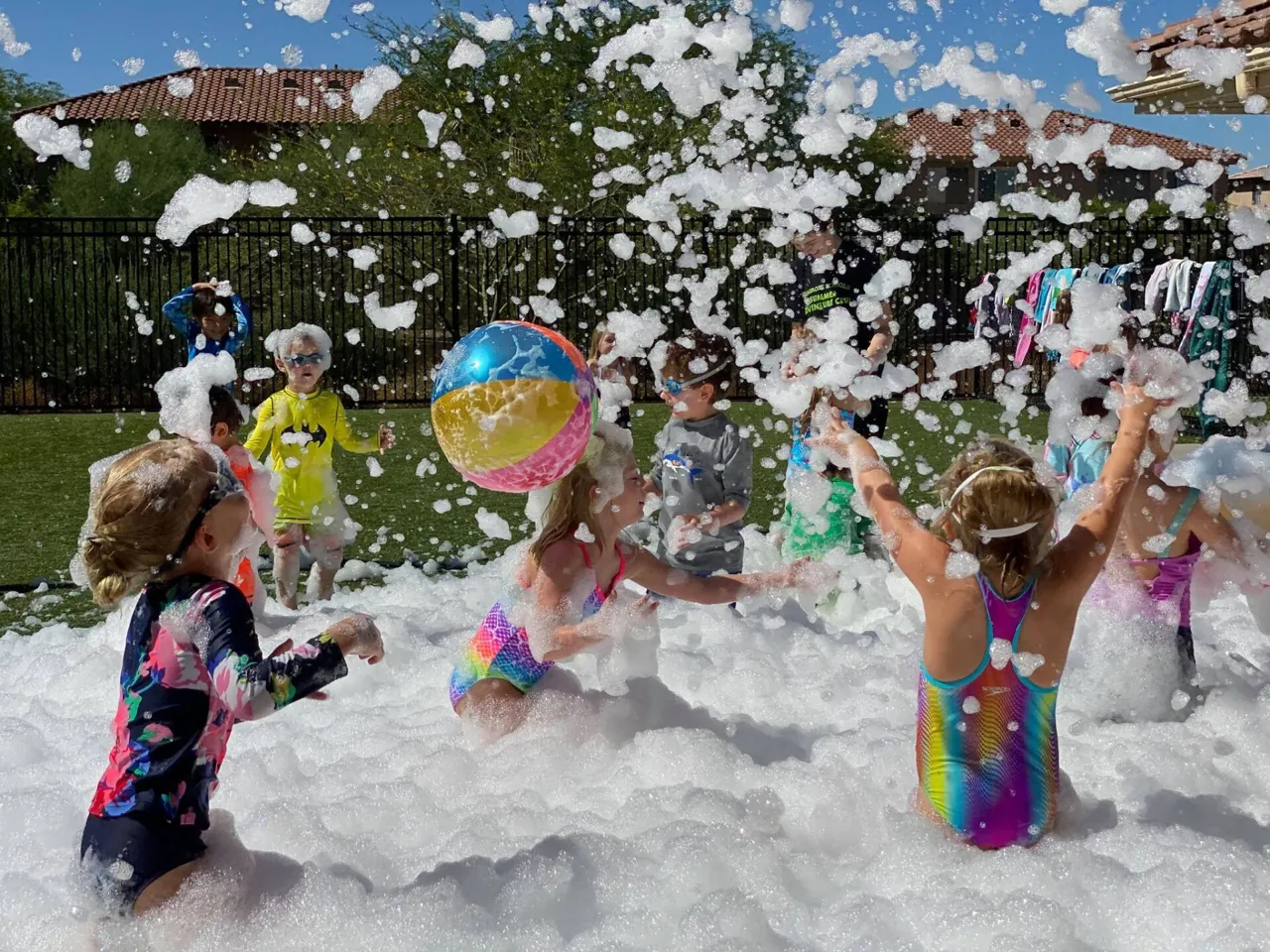 Kids playing with beach balls in the foam