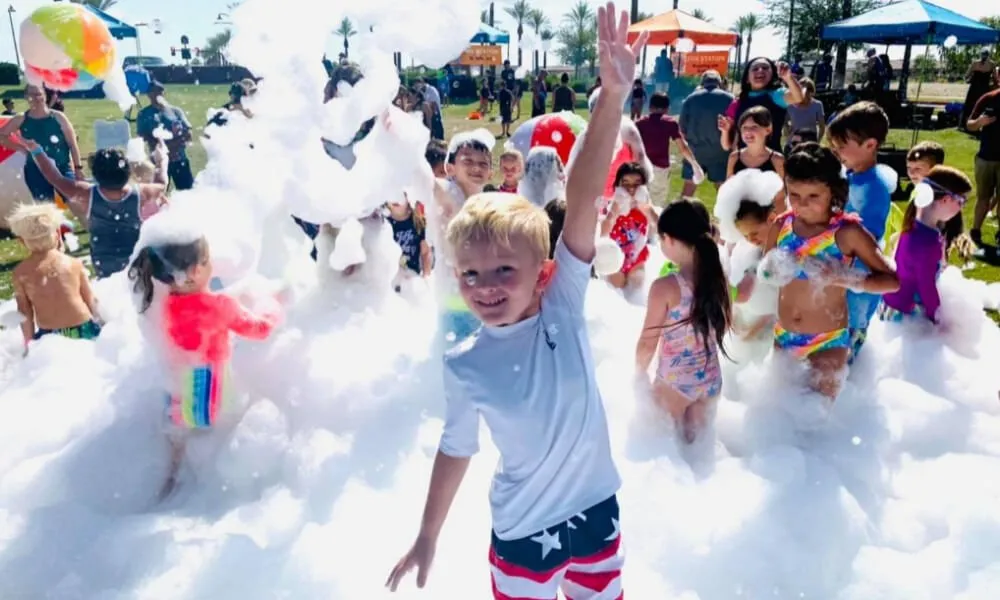 Boy cheering at a community foam party