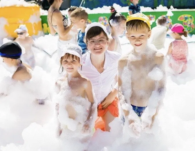 Smiling kids covered in foam